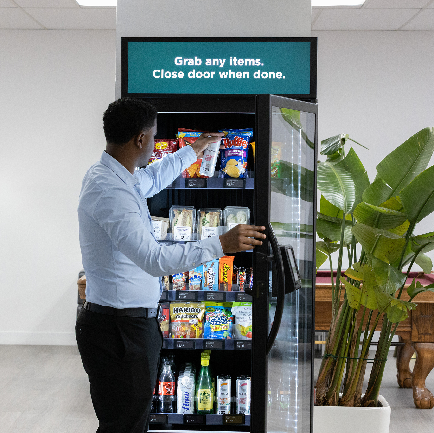 A person reaching into an open Smart Vending Machine